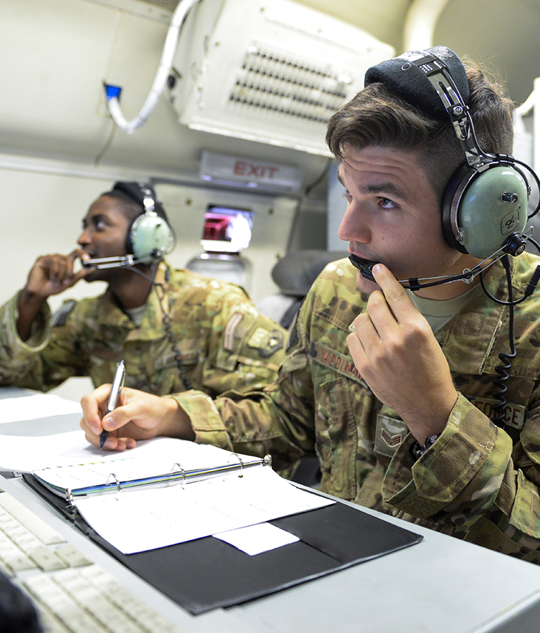airman speaking on a headset and taking notes