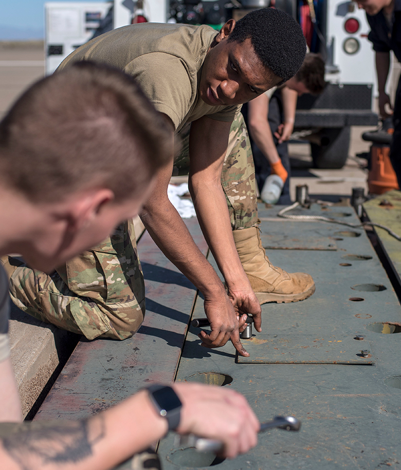 airmen working on electrical equipment