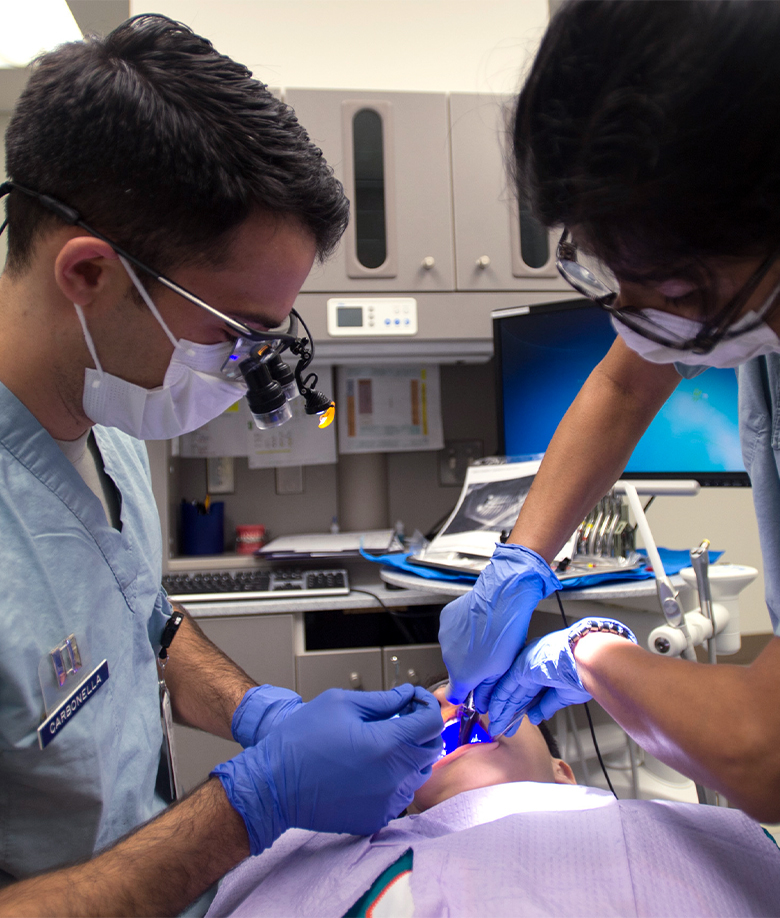 Orthodontists working on a patient