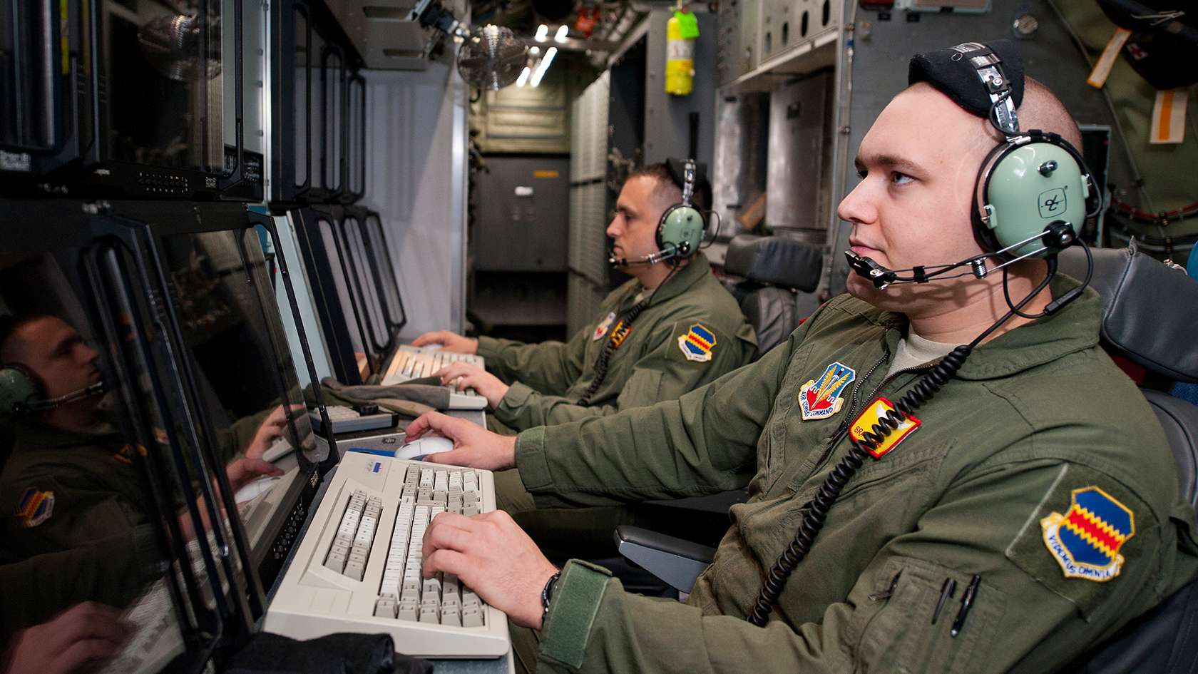 airmen viewing content on computer screens