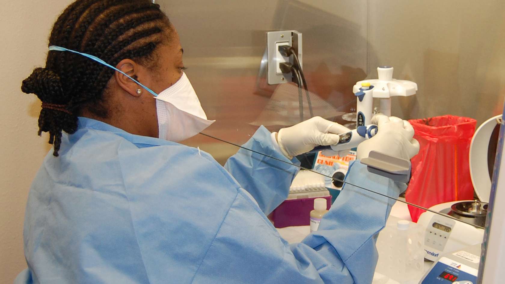 CLINICAL GENETICIST preparing testing instruments