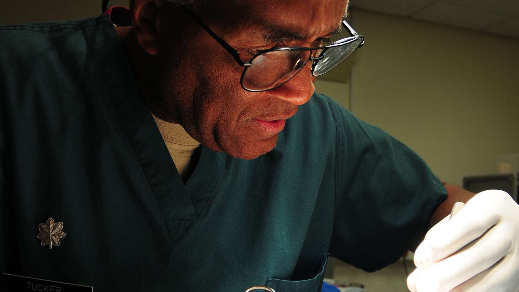 male dermatologist inspecting