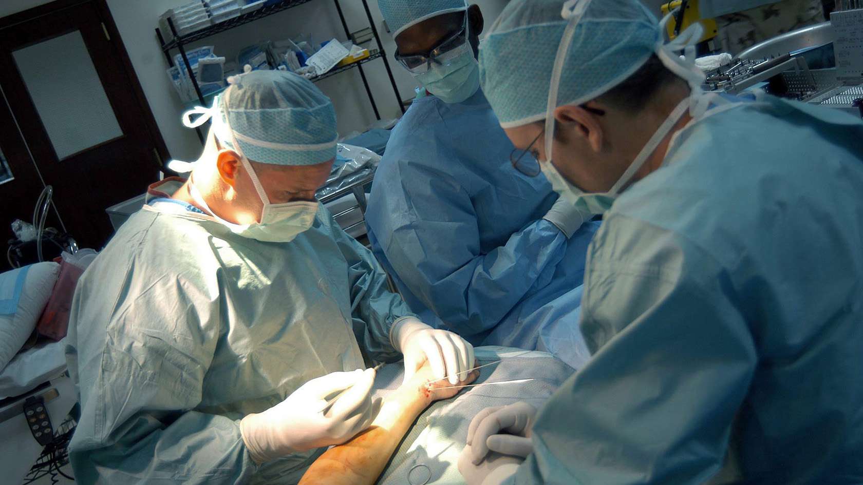 orthopedic surgeon and his team working on a patient's arm