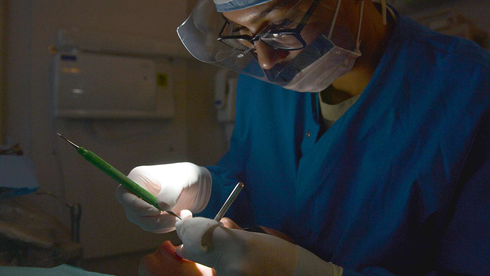 periodontist examining patient's gums