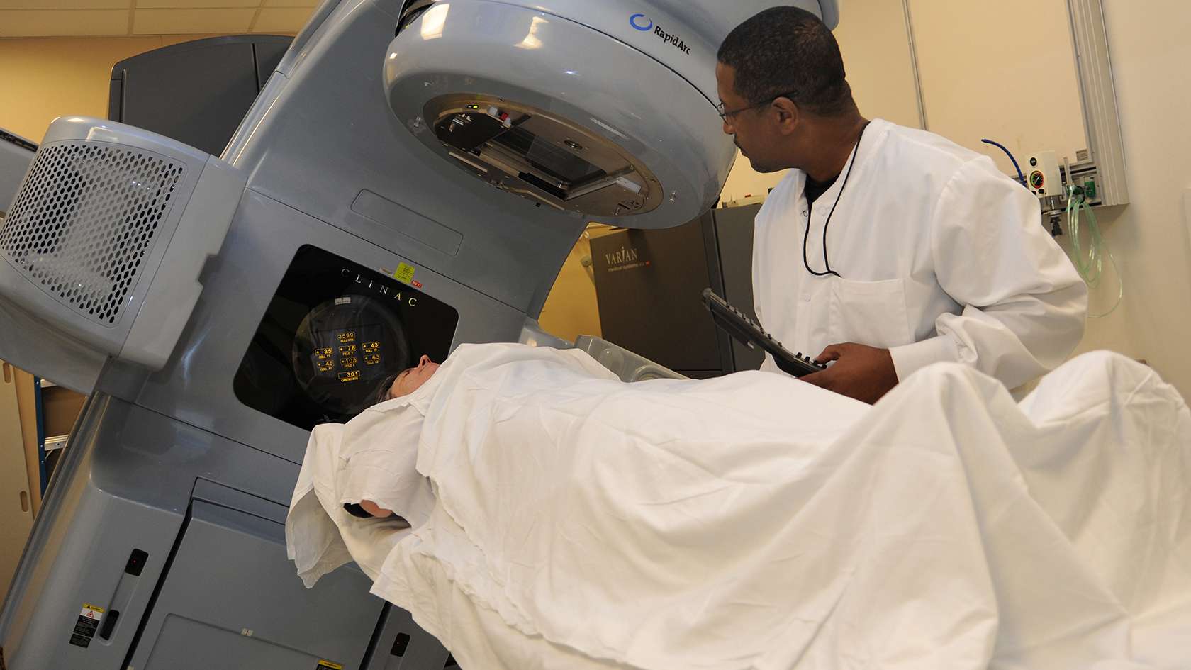 Radiotherapist talking to a patient in scan