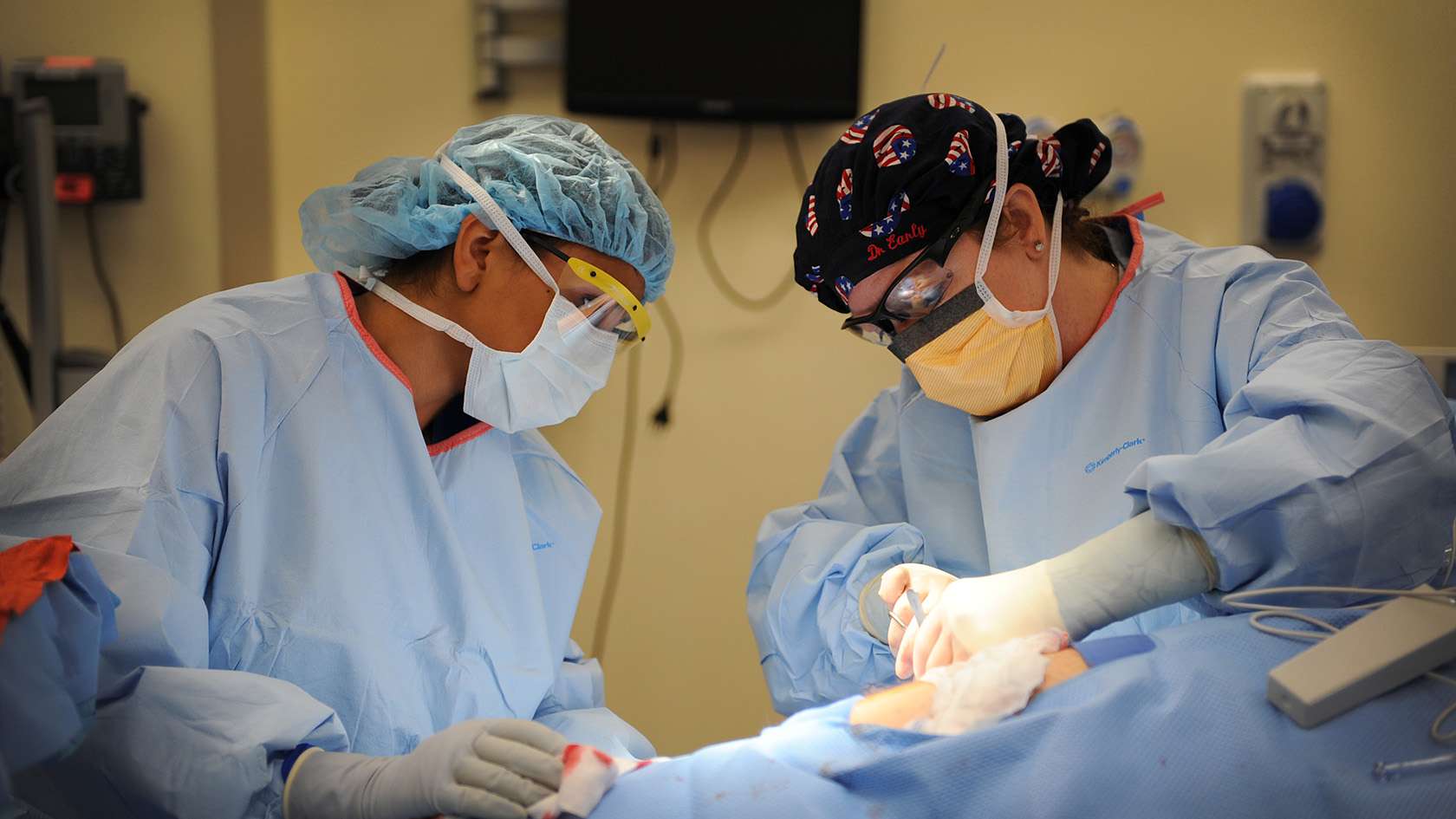 surgical team of two working together on a patient