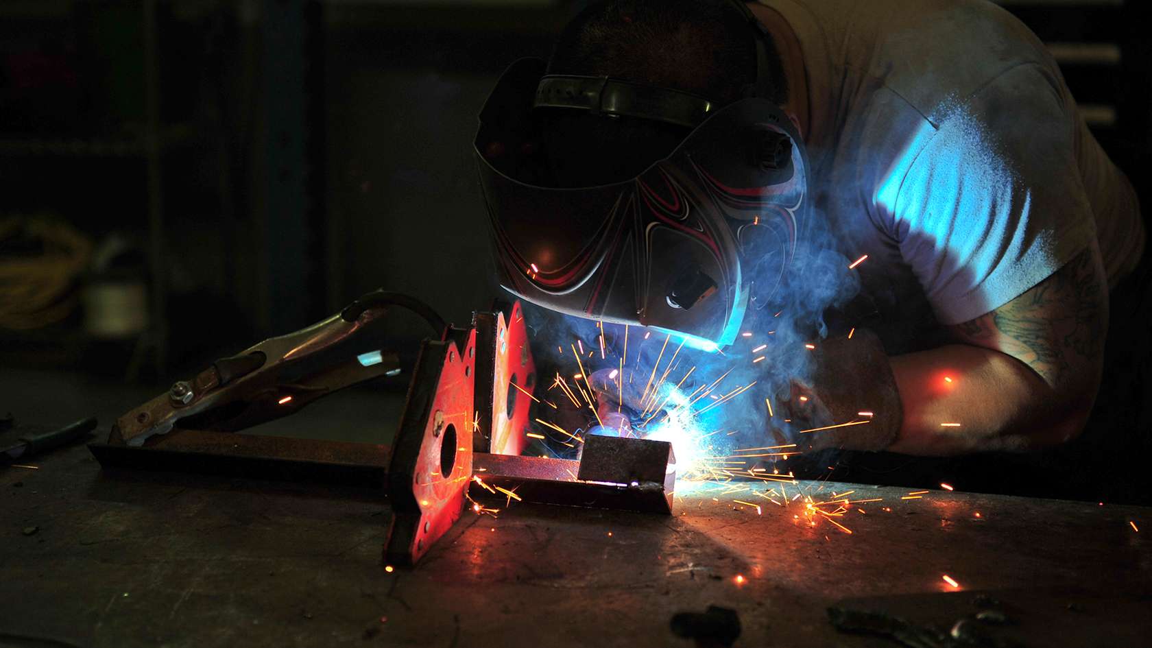 airman repairing vehicle part