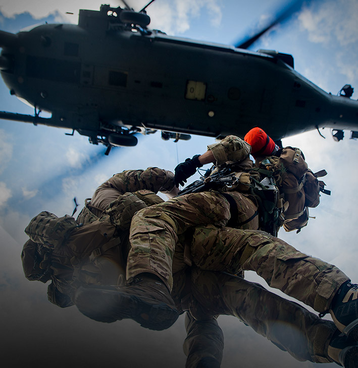 PARARESCUE (PJ) Airman on his way up to the helicopter during a rescue mission