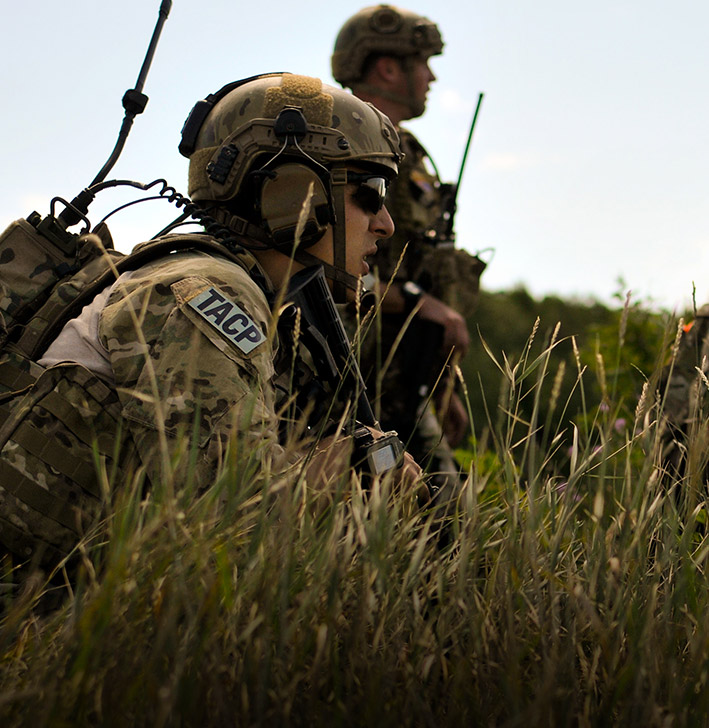 a group of TACTICAL AIR CONTROL PARTY airmen hiding in grassy fields