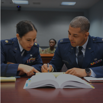 Air Force JAGs talking in a court room