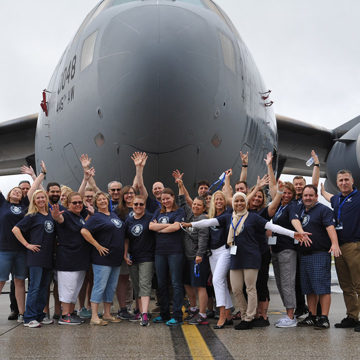 First Leadership Experience Attendees Standing by Aircraft