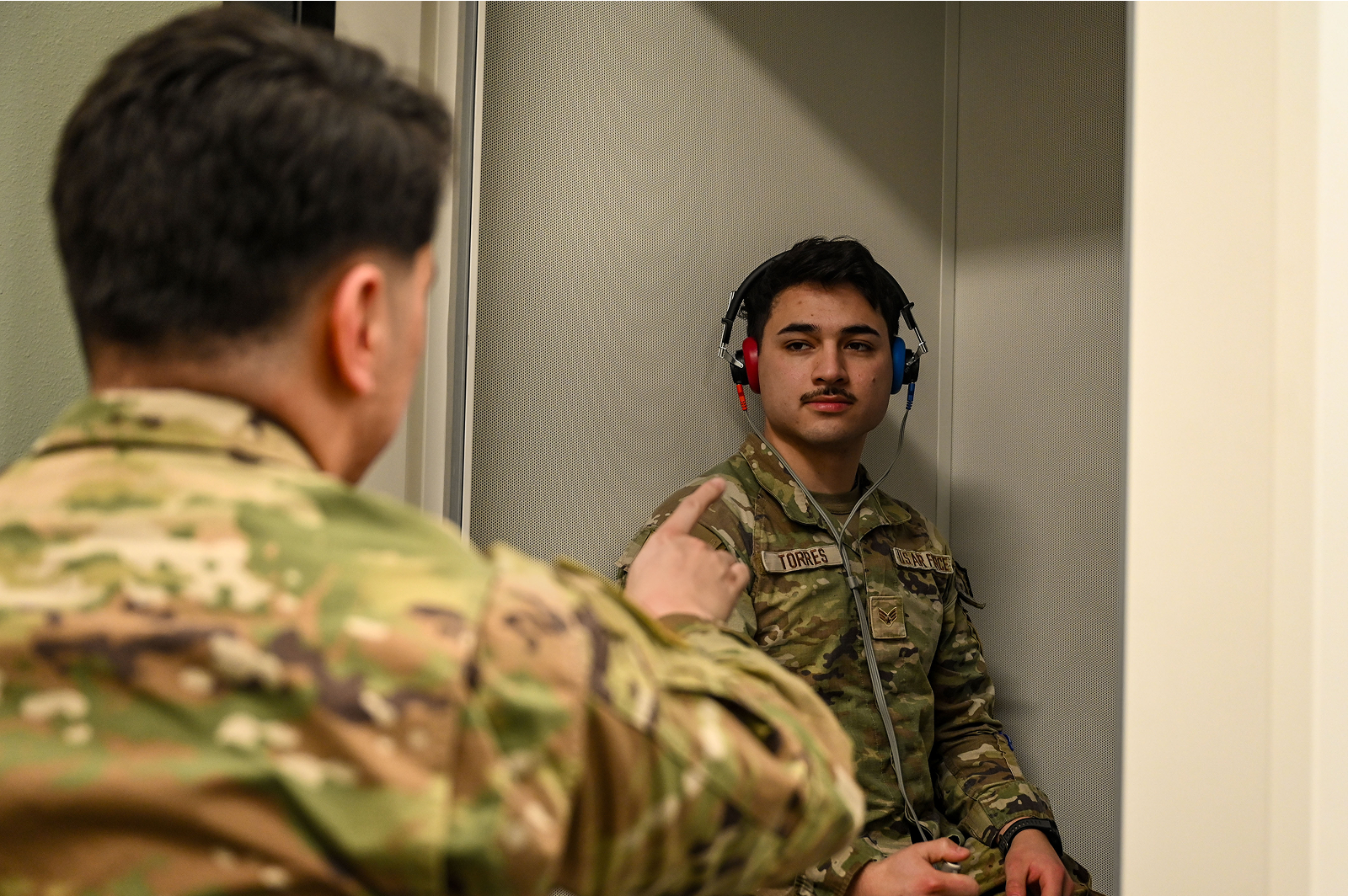 audiologist testing airman's hearing