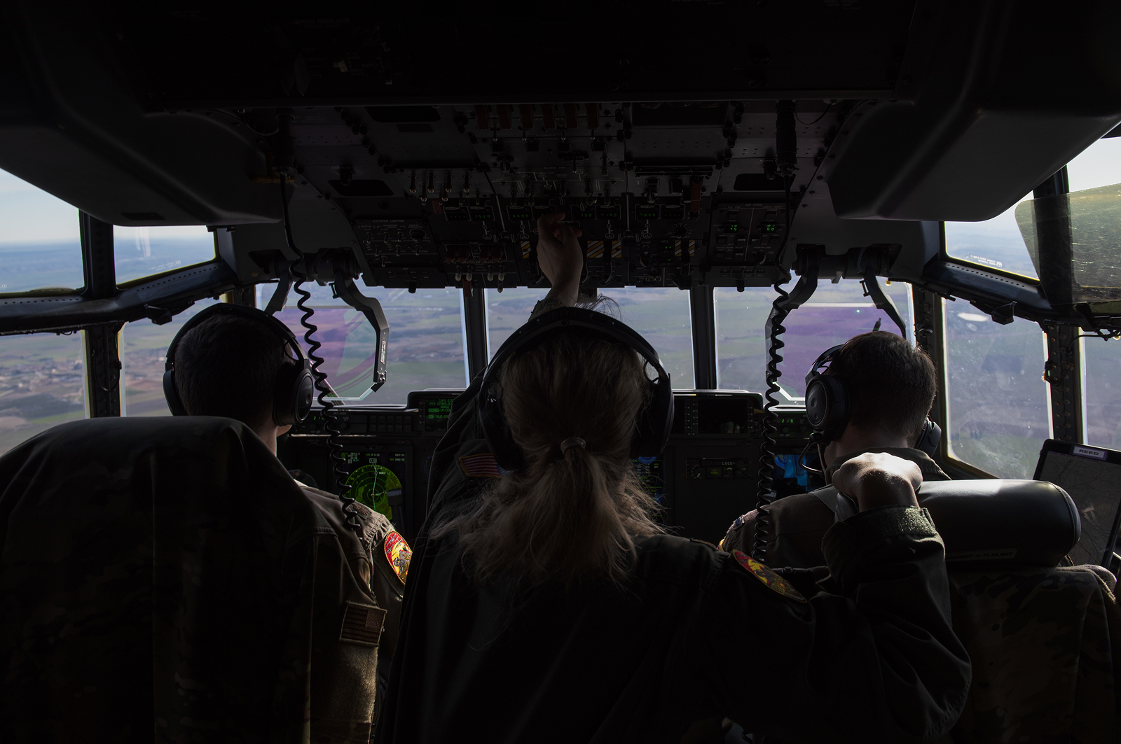 pilot physician and pilots sitting in cockpit of plane