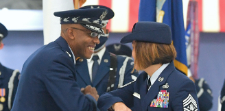 Chief of Staff and Chief Master Sergeant bumping elbows 