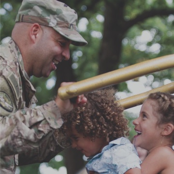 Airman playing with two small children