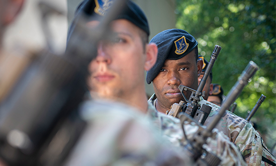 security forces staff holding rifles