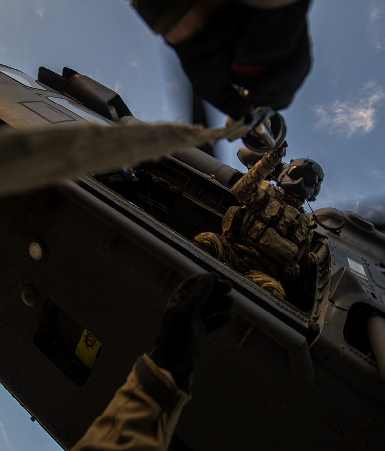 airman dropping a hoist from a helicopter
