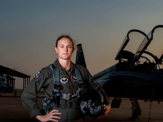 Female pilot in front of fighter jet