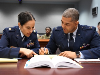 Two Air Force JAGs reading law textbook