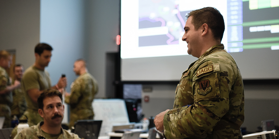 JAG officer talking to colleagues