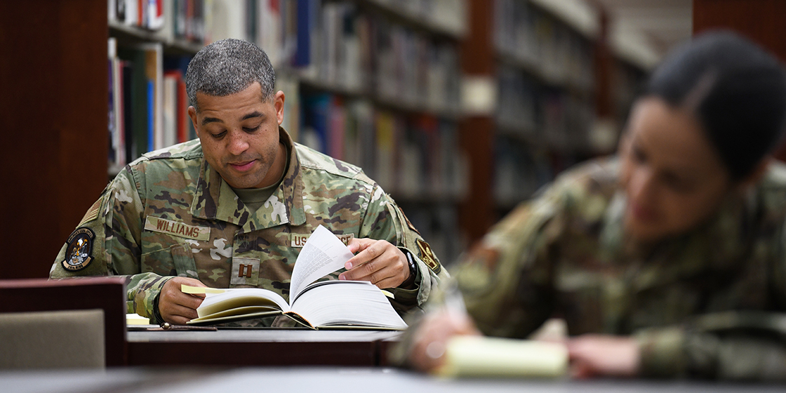 JAG officer in the library doing research