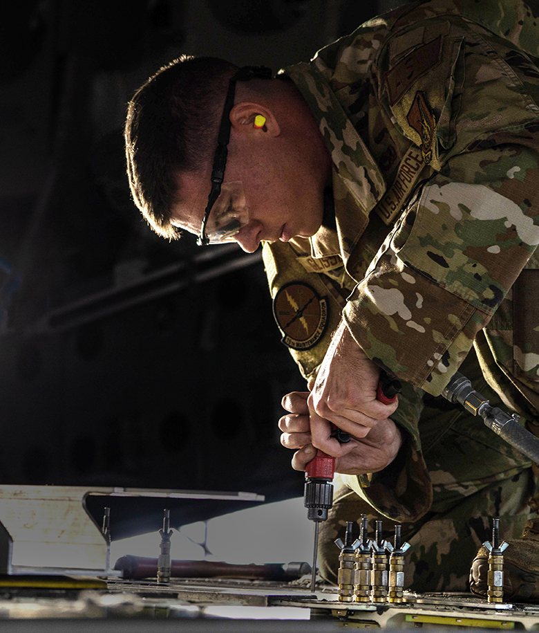 airman installing replacement aircraft parts