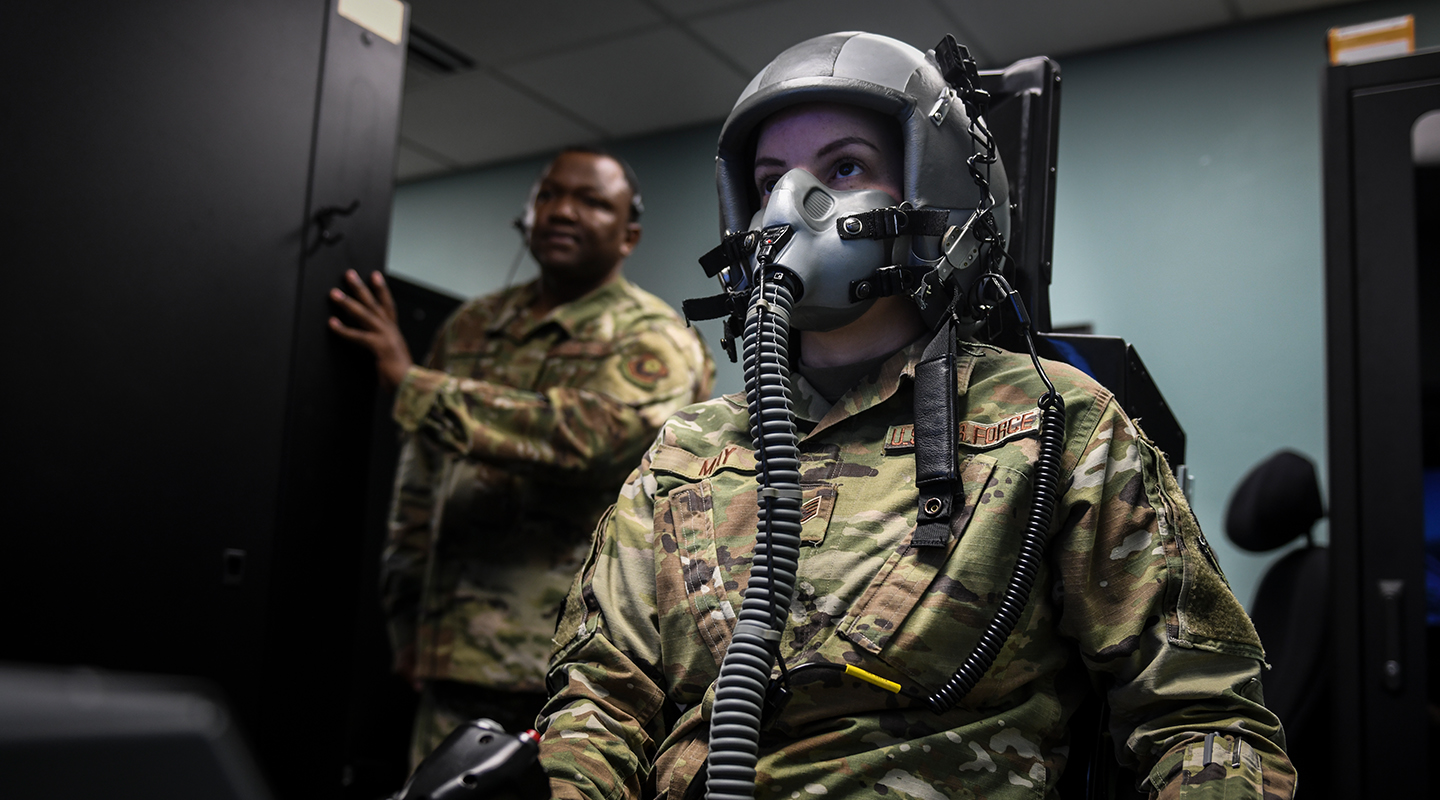 airmen in front of computer screens conducting training