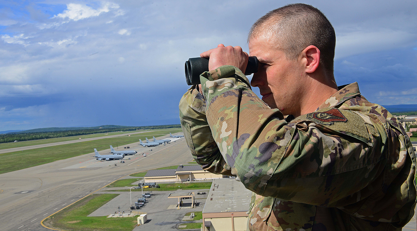 airman looking through binoculars