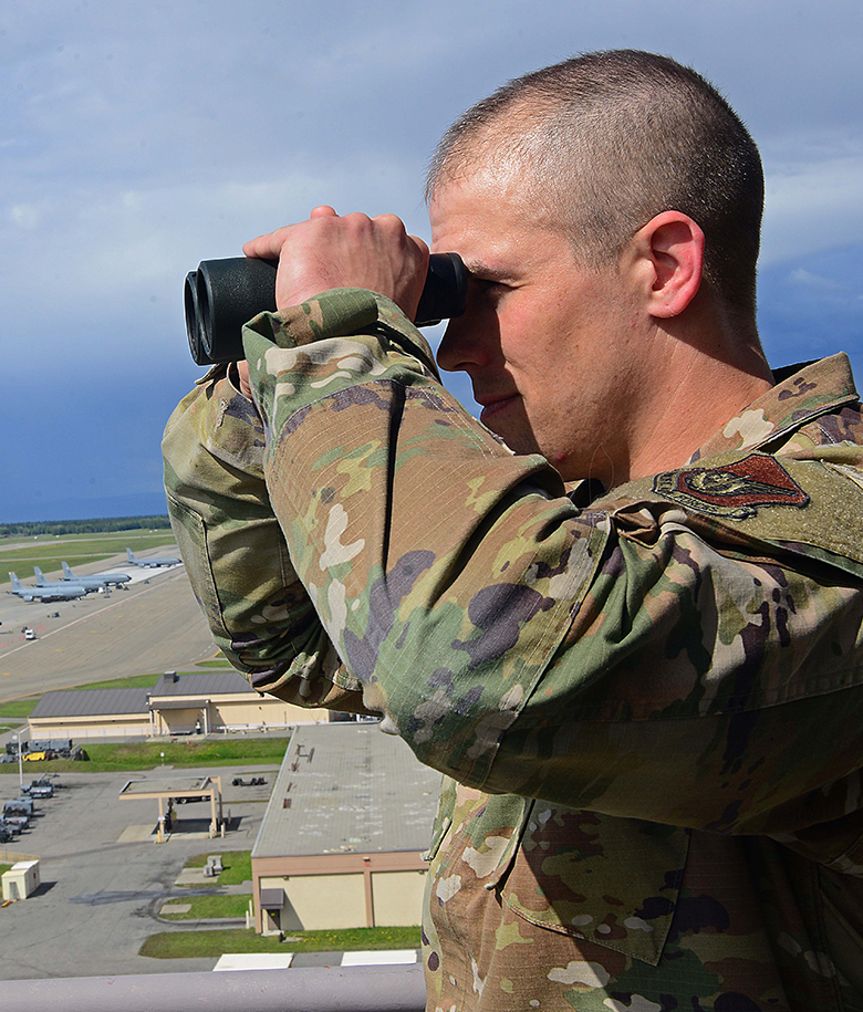 airman looking through binoculars