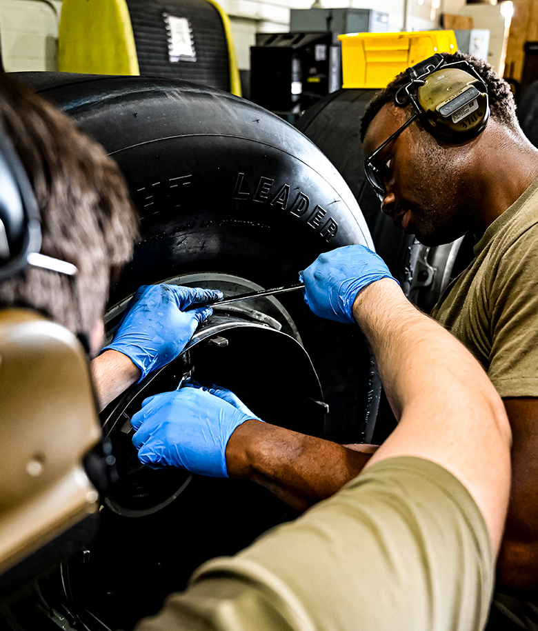 airmen ensuring aircraft tires are in optimal condition pre-flight