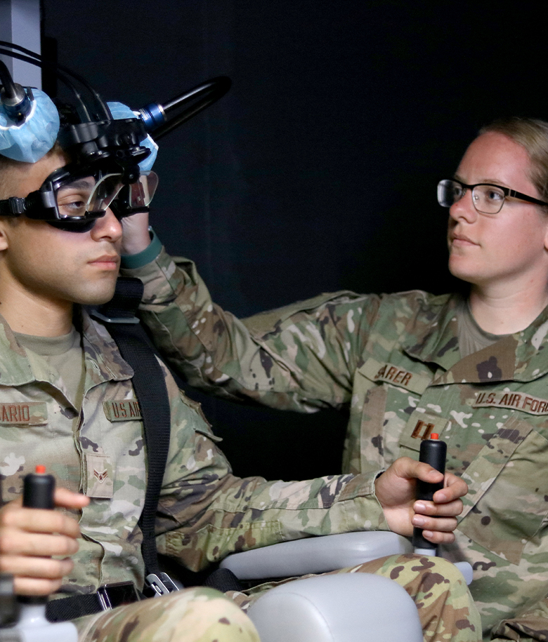 audiologist helping airman with audio exam