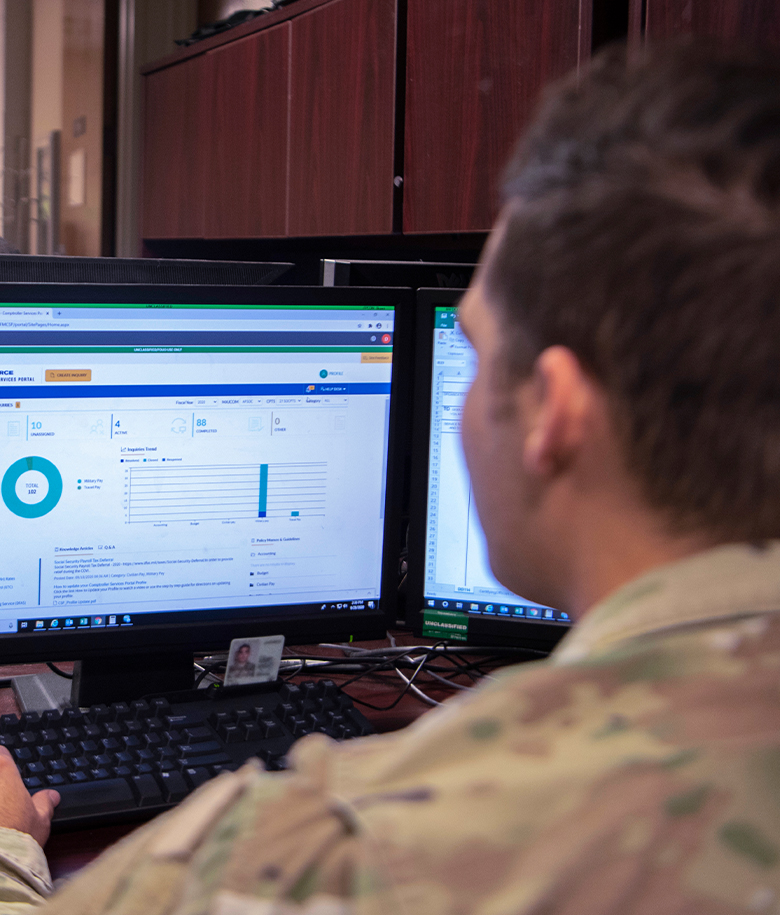 airman reviewing information on computer screen