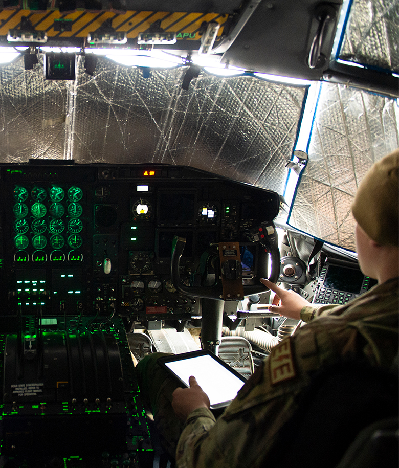 airmen operating cockpit equipment
