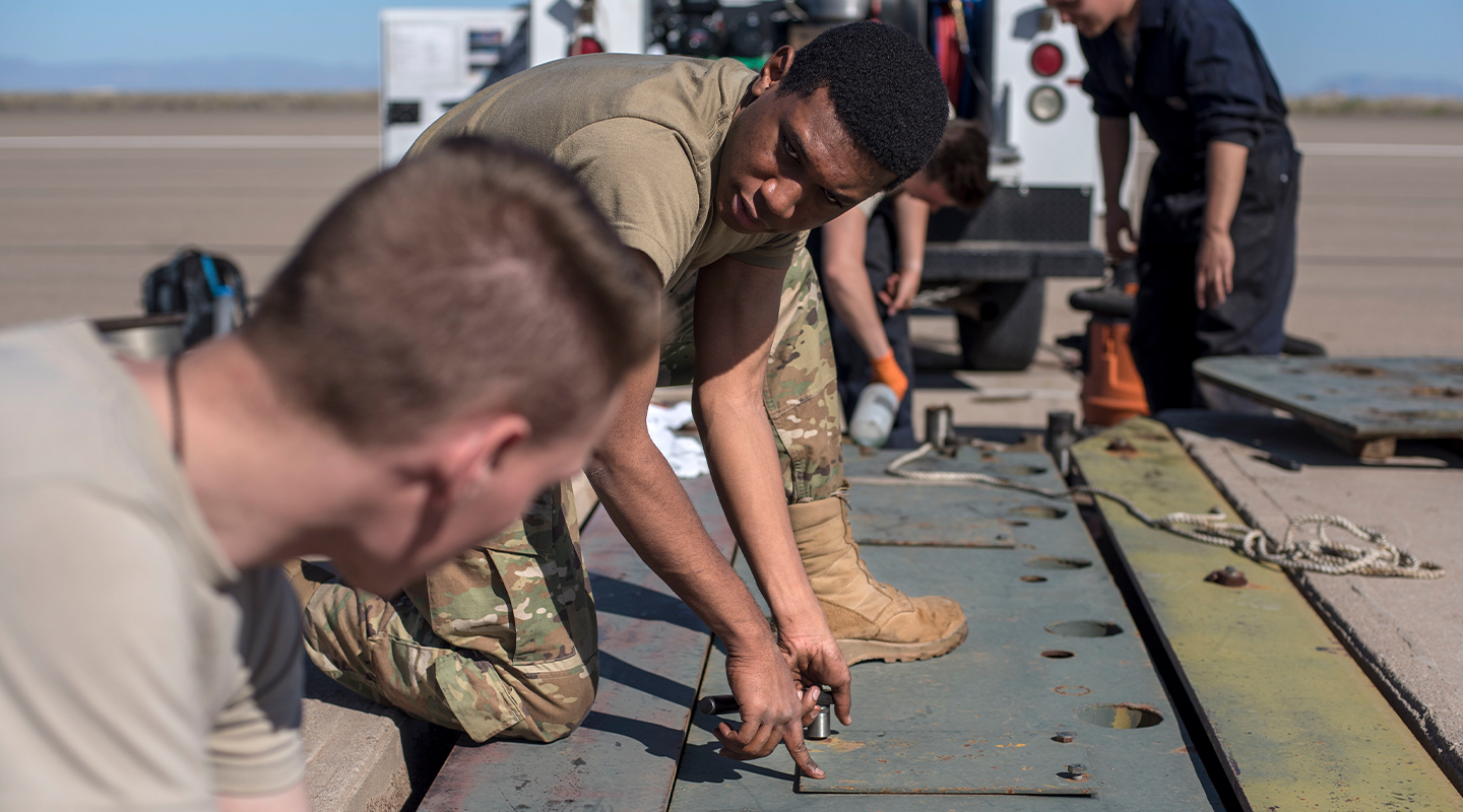 airmen working on electrical equipment