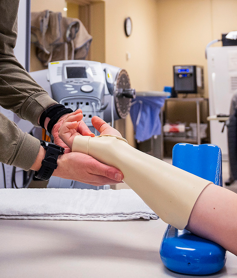 occupational therapist inspecting a prosthesis 