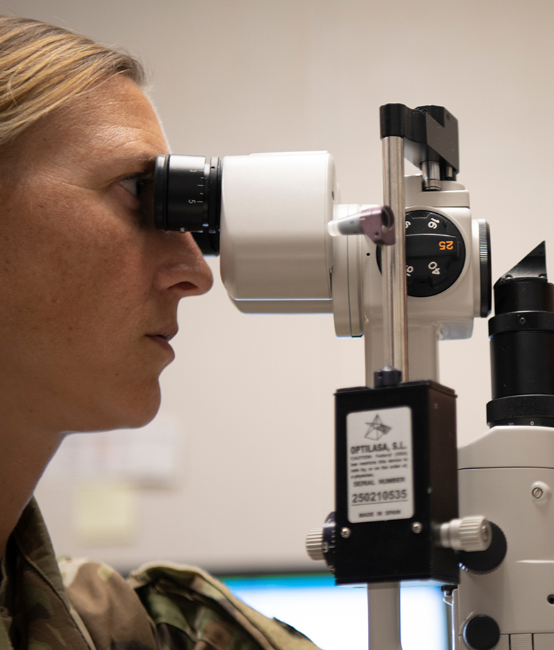 airman inspecting patient's eyes