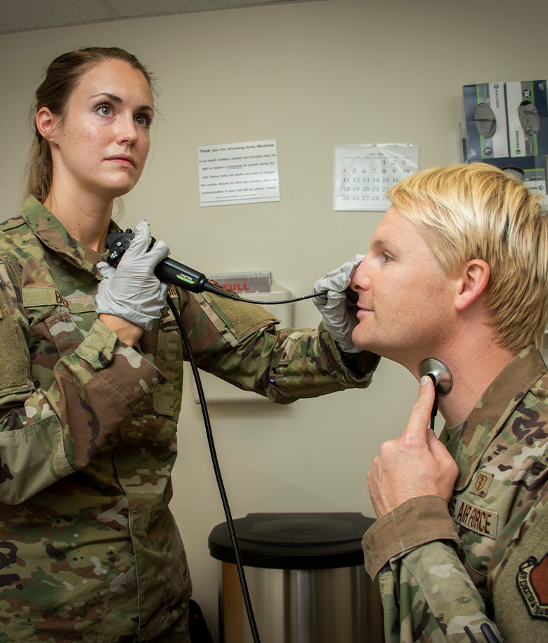 OTORHINOLARYNGOLOGIST examining a patient