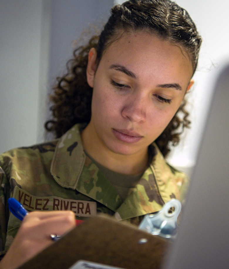 airman writing on a clipboard