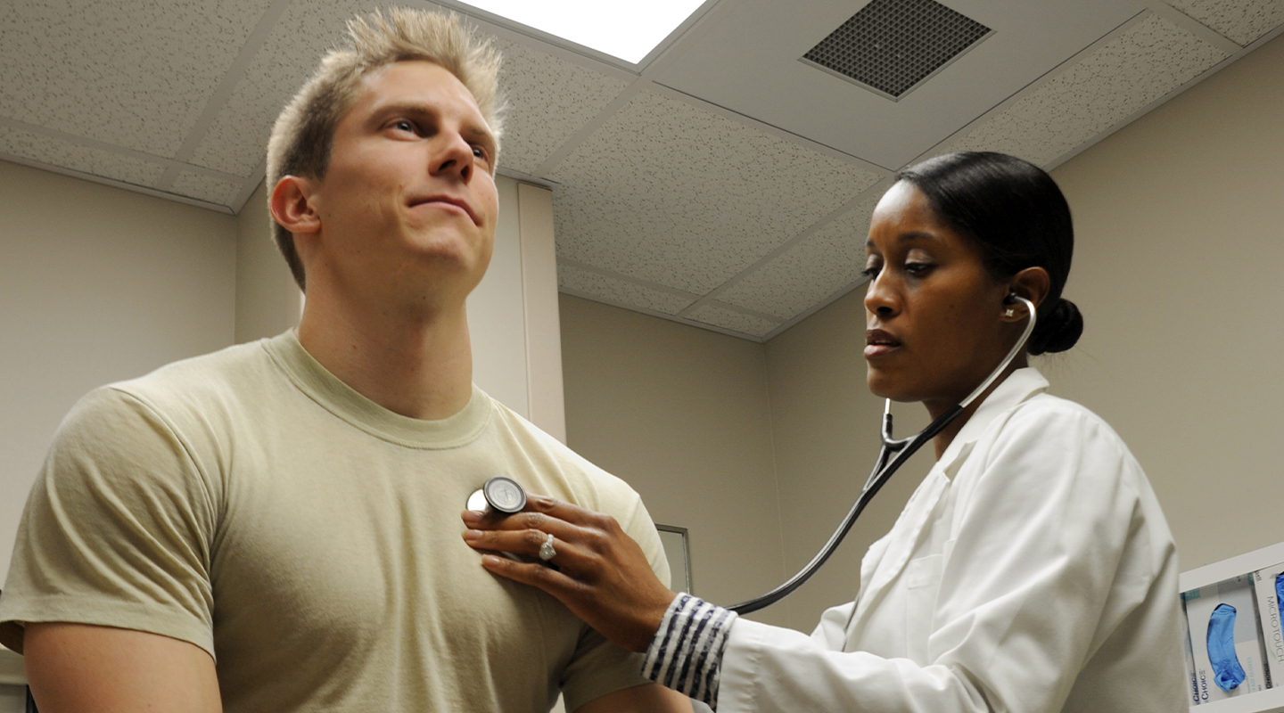 physician assistant listening to patient's heartbeat
