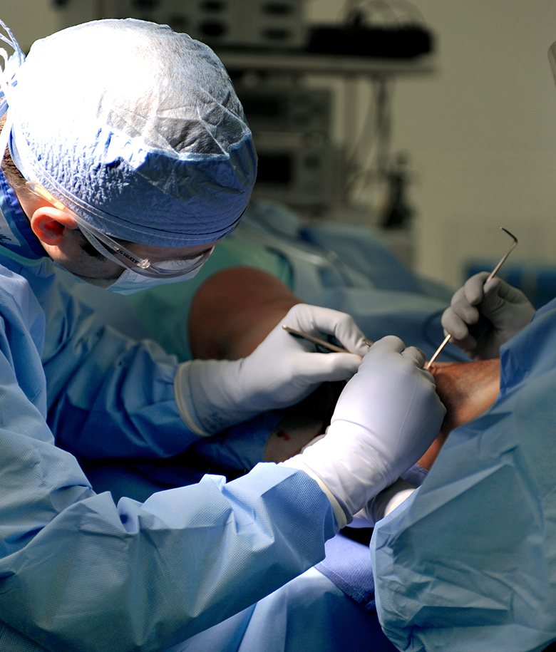 podiatric surgeon operating on a foot