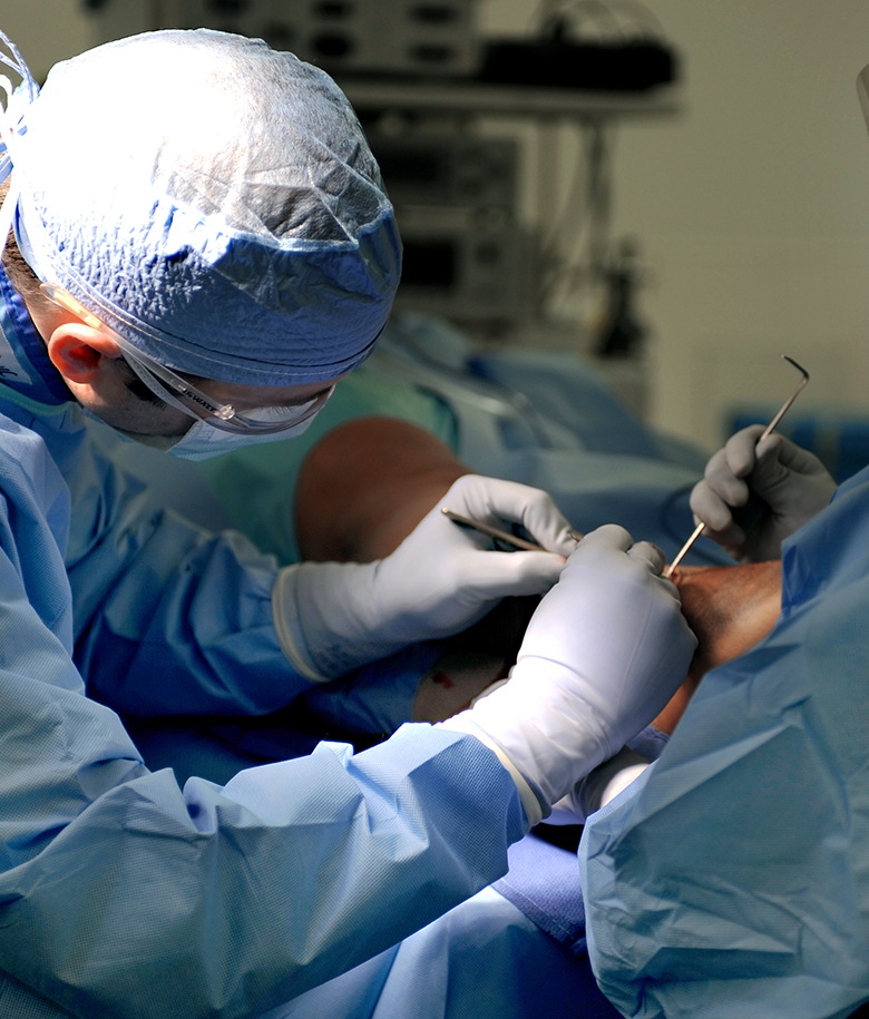 podiatric surgeon operating on a foot
