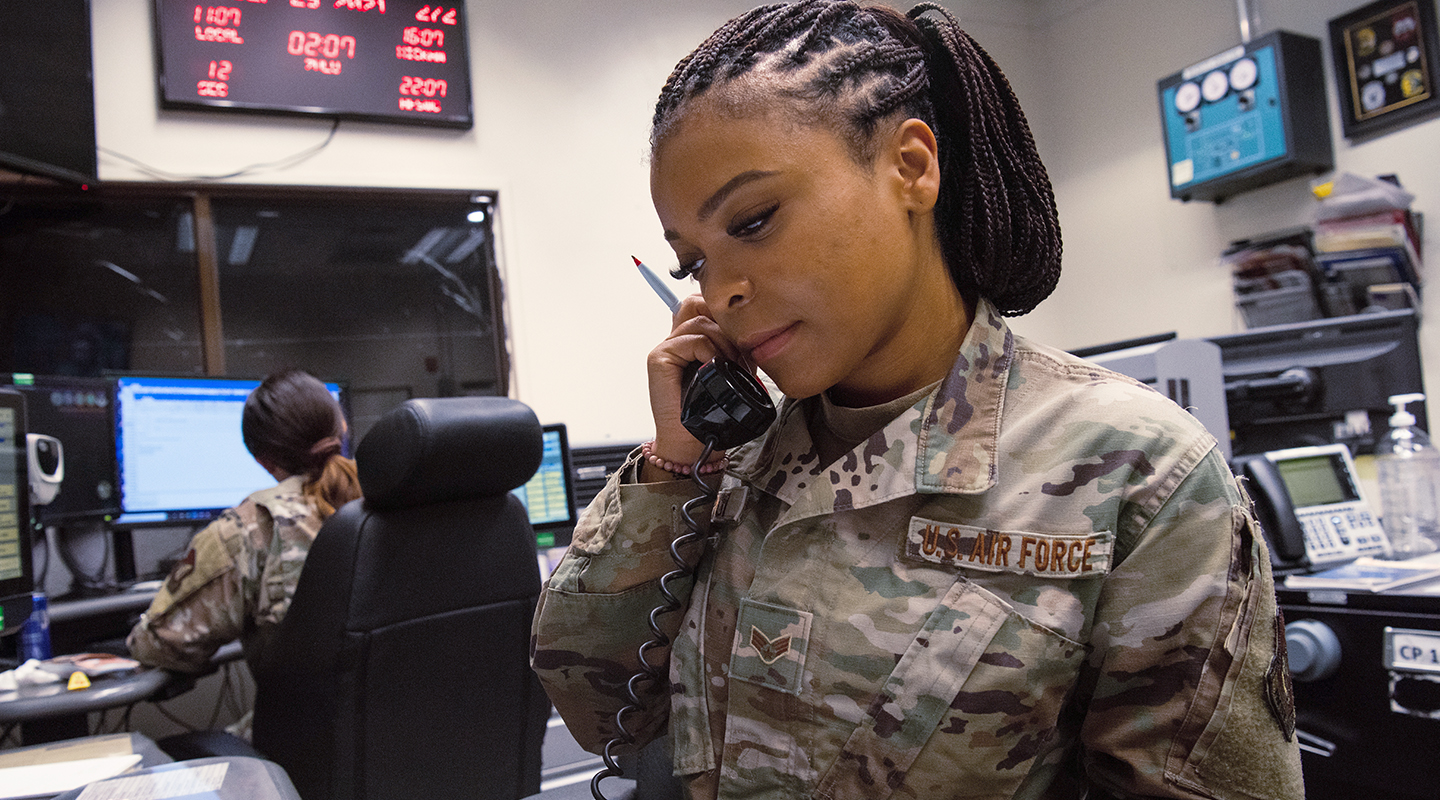 airman on phone reviewing papers