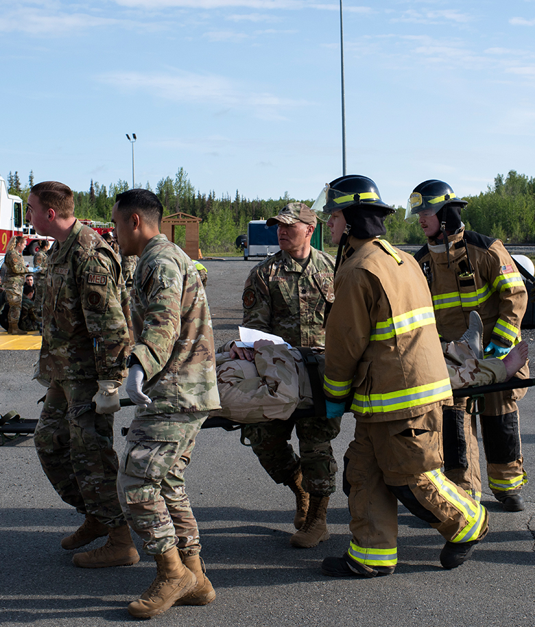 emergency management personnel carrying patient