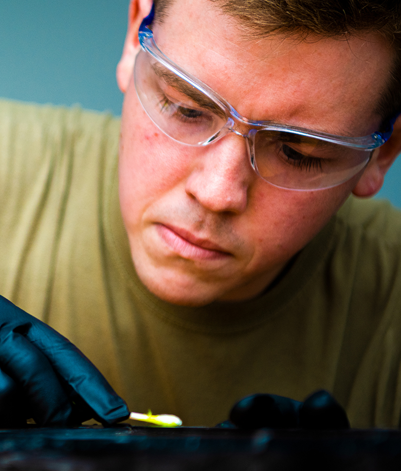 airman inspecting metal