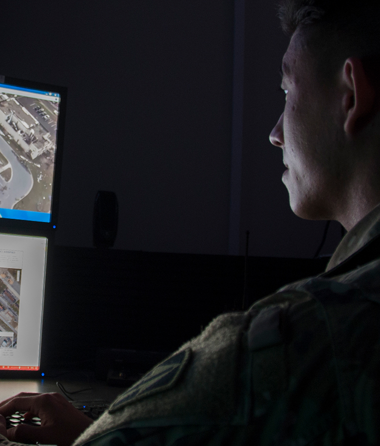 Signals Intelligence Analyst reviewing screens