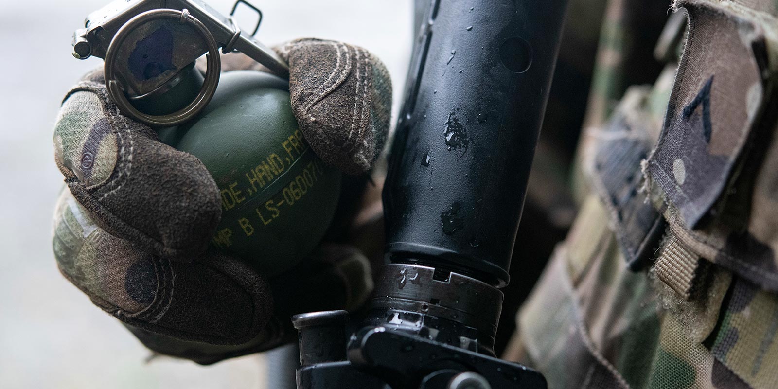 Airman holding a M67 Fragmentation Hand Grenade