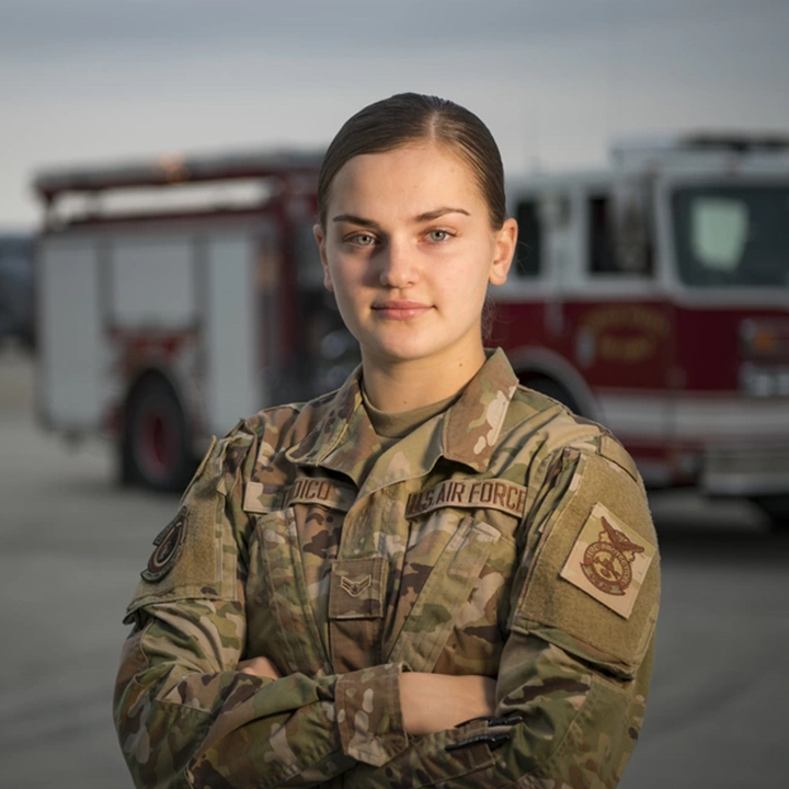 Airman posing in front of fire truck