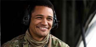 airman wearing headset and smiling