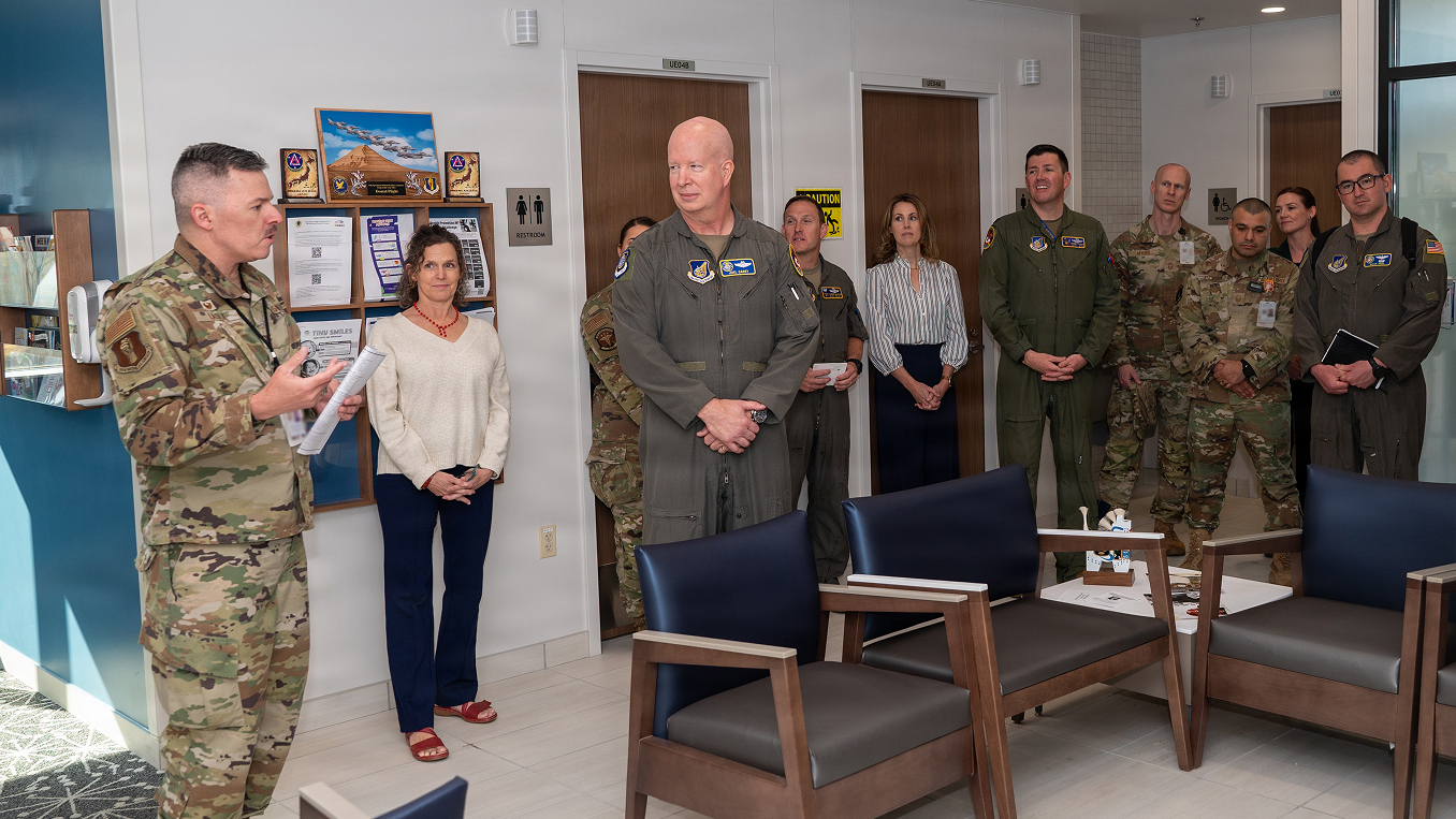 airmen and civilians standing in waiting room