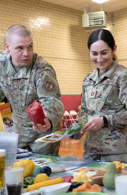 airmen looking at vegetables